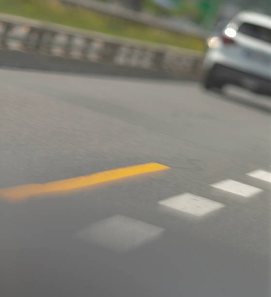 istock A blurry image showing a car that is driving along a road 2225836628