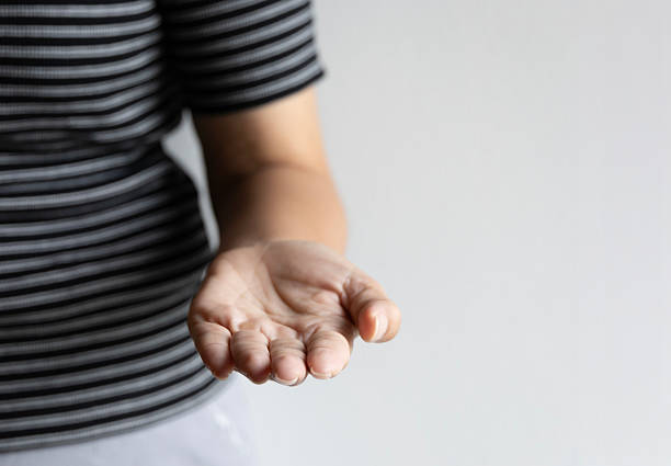 istock Isolated woman hand open palm relaxed fingers soft light white background gentle gesture invitation symbolizing human interaction calm touch natural beauty communication simple hand signs. 2225837785