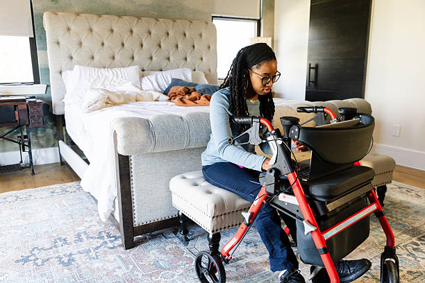 istock Young Woman Using Laptop on Walker in Bedroom 2225837896