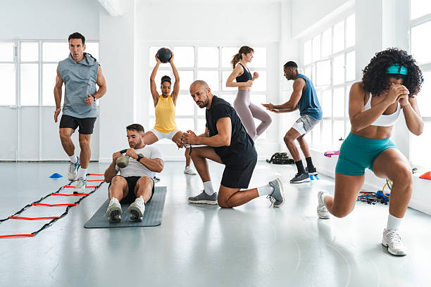 istock Athletes training with personal trainer in functional fitness gym 2225838850