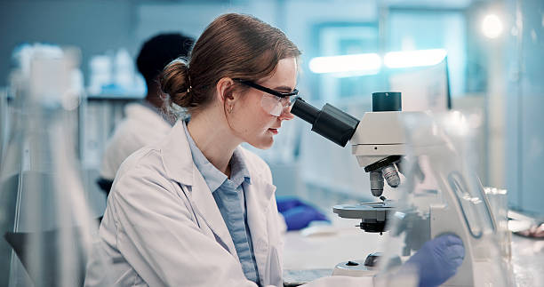 istock Science, microscope and woman in laboratory for research, development or inspection. Vaccine analytics, medicine and scientist with equipment for medical study, internship and biotech engineering 2225839503