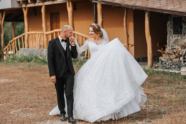 istock A bride and groom are walking together in a field 2225839815