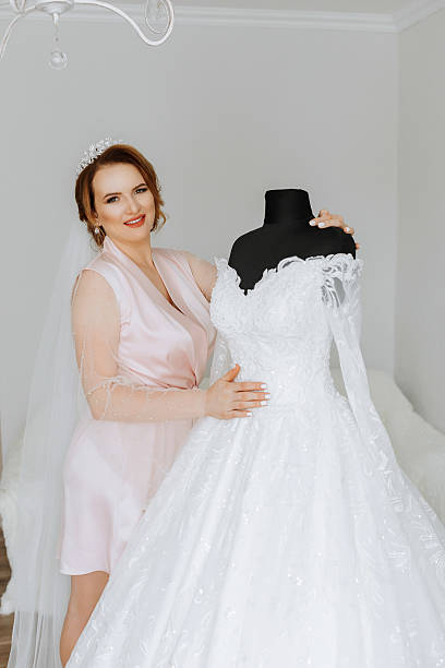 istock A woman is holding a wedding dress 2225839974