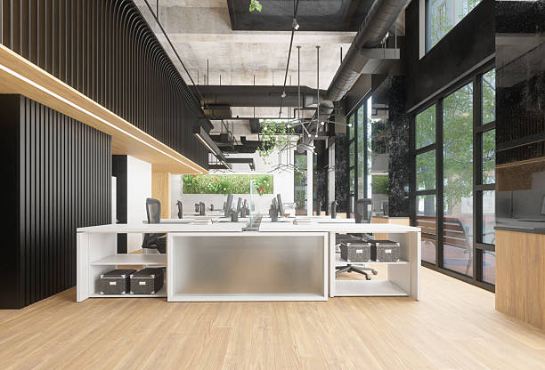 istock Clean modern office space with multiple workstations and green plants. Contemporary empty open-plan office interior with large windows. 2225841001