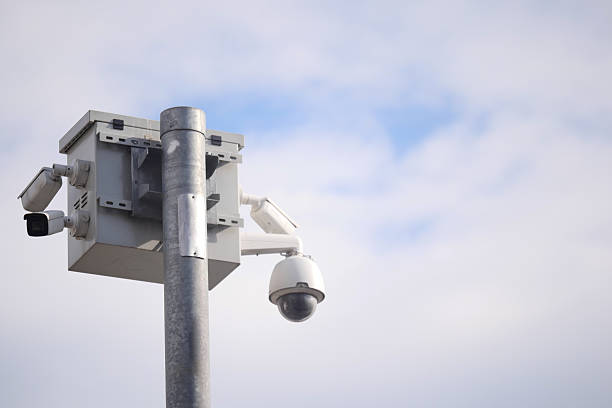 istock Security camera setup monitoring urban environment on clear day 2225842300