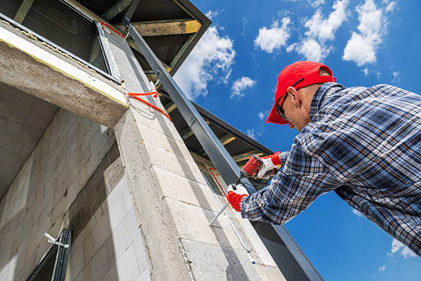 istock Worker Applying Finishing Touches to Exterior Wall During Construction in Bright Sunshine 2225842801