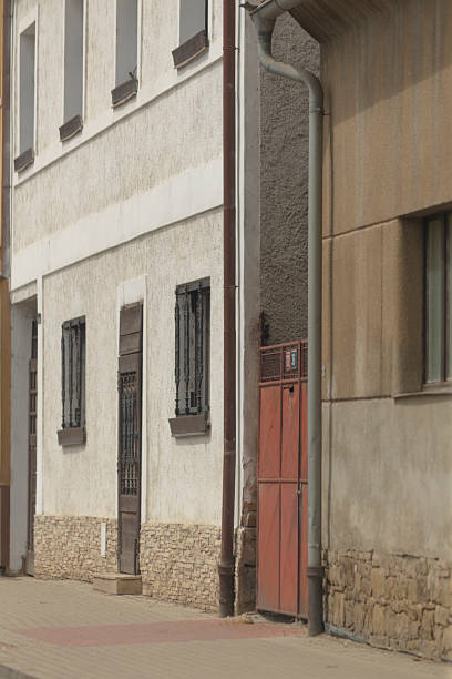 istock A building with a vibrant red door and a drainpipe on its side 2225844668