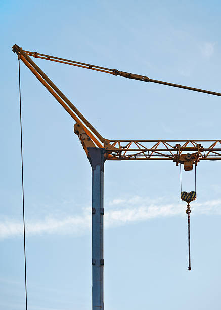 istock Small industrial crane against clear blue sky 2225845163