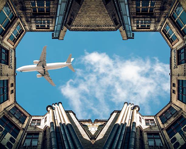 istock A large passenger plane flies low over city buildings 2225849463