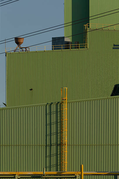 istock A large green building featuring a bright yellow ladder positioned on its side 2225849955