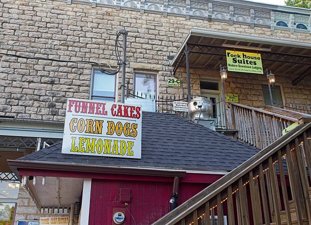 Eureka Springs, Arkansas - USA, May 9, 2025. Rustic funnel cake corn dog stand in downtown Eureka Springs, Quaint downtown architecture in the middle of the Ozark mountain community of Eureka Springs Arkansas.