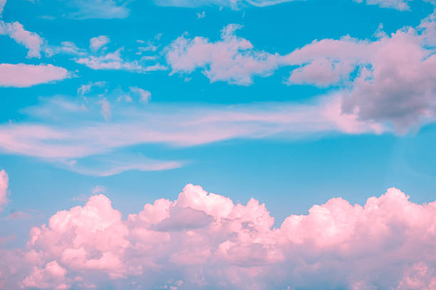 istock Drifting pink and white cumulus clouds float across a vibrant blue sky, crafting a dreamy and surreal atmosphere that evokes feelings of tranquility and inspiration 2225851790
