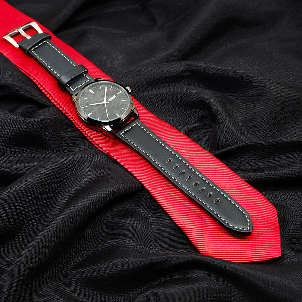 istock Watch and tie closeup shot on black background 2225859373