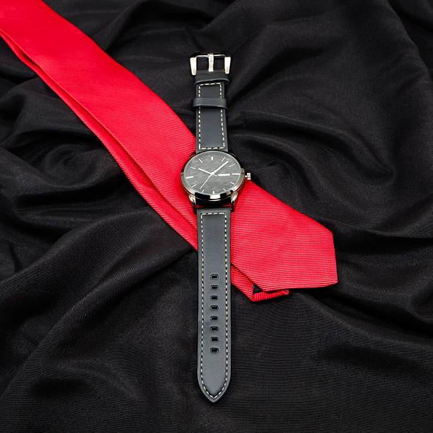 istock Watch and tie closeup shot on black background 2225859409
