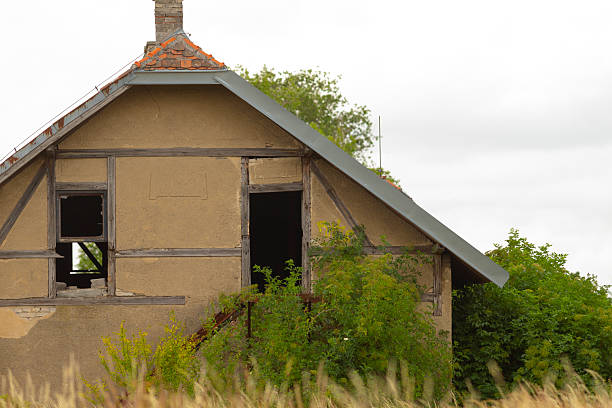 Old creepy abandoned house on the Swedish countryside, standing alone all run downed and worn