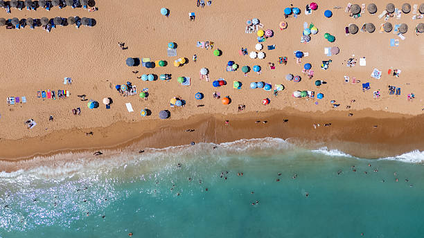 istock Colorful Parasols on Albufeira Beach from Above 2225860822