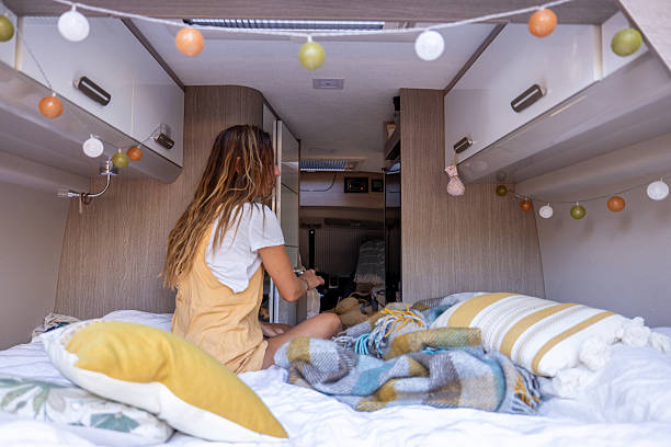istock Woman Relaxing Inside Cozy Van Life Bedroom 2225861114