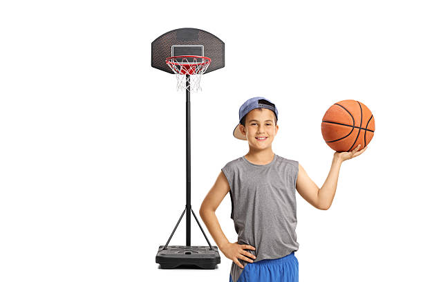 istock Boy with a cap holding a basketball 2225861173
