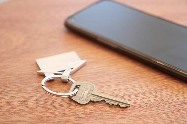 istock Keys and smartphone on a wooden table in a cozy indoor setting 2225862009