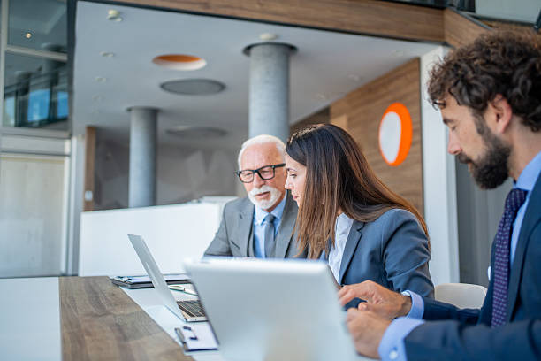 istock Business team working together on laptops in modern office 2225862464