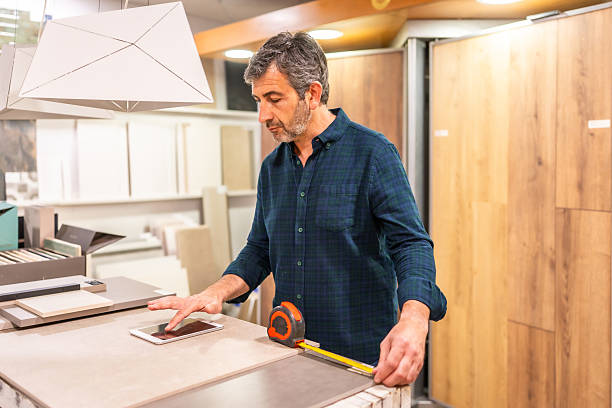 istock Architect taking measures of ceramic tiles using digital tablet and tape measure 2225864164