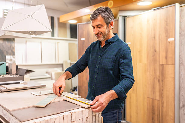 istock Architect choosing tiles and measuring with a ruler in a home improvement store 2225864167
