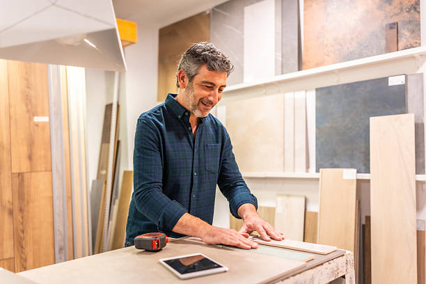 istock Architect choosing tiles and wood samples for renovation project in store 2225864213