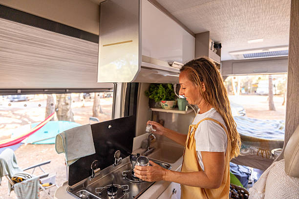 istock Woman Cooking Inside Cozy Camper Van Kitchen 2225864301