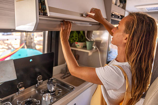 istock Woman Reaching for Coffee Supplies in Van Kitchen 2225864450