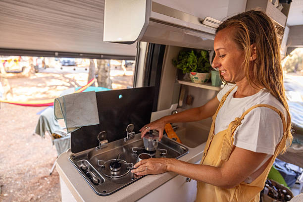 istock Woman Making Coffee Inside Cozy Camper Van Kitchen 2225864684