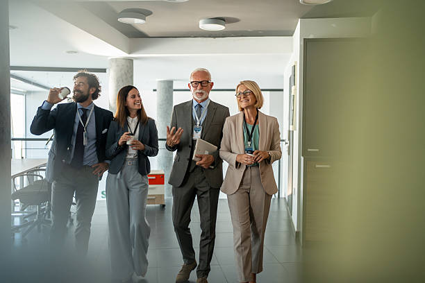 istock Businesspeople walking and talking in office corridor 2225866683