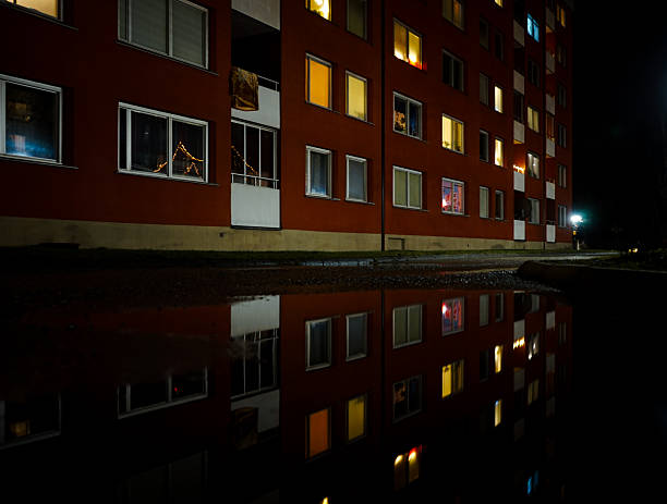 View of water puddle next to a building night