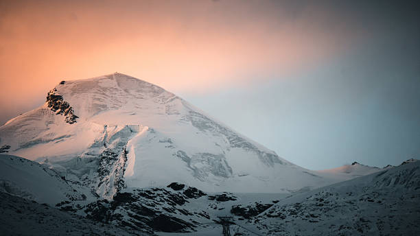 Alpine glow on snowcapped mountain and glacier, Swiss Alps
