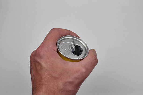istock Hand holding a opened soda can 2225870522