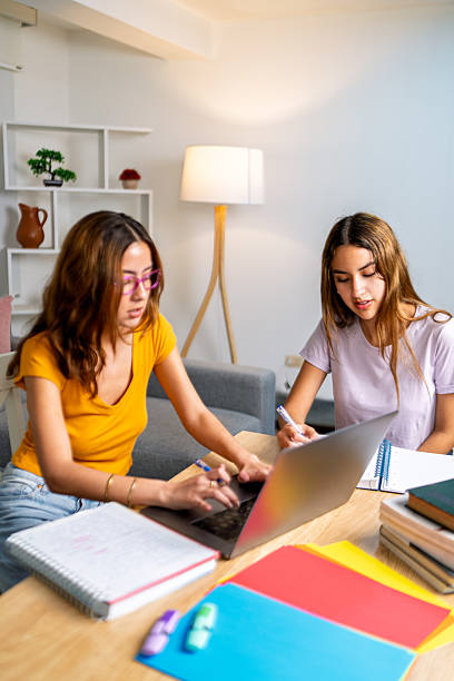 istock Two young women doing homework on laptop at home 2225880177