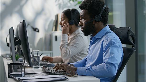 istock Diverse callcenter collaboration Caucasian boss explaining task pointing finger African operator headset Indian female work computer business call center customer support office communication training 2225883178