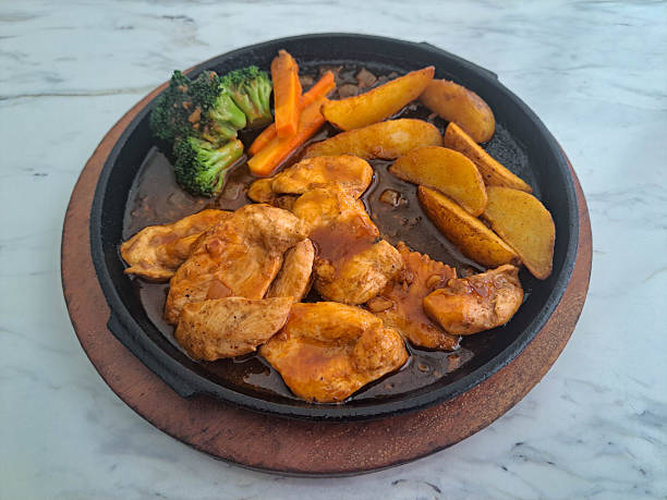 Tasty Chicken Cutlet Steak With Griled Chicken Meat, Potato Wedges, Vegetable And BBQ Sauce. Food Menu.