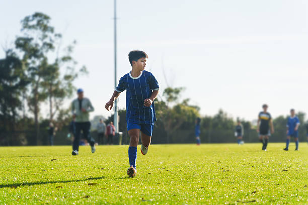 istock Running football player on grassy field. 2225884816