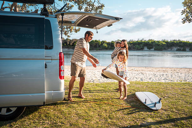 istock Young Family Enjoying Beach Camping with Surfboard 2225890568