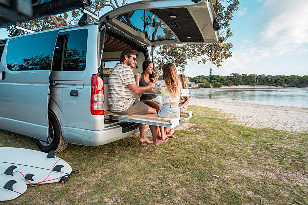istock Young Family Dining Outdoors by the Sea With Minivan 2225890584