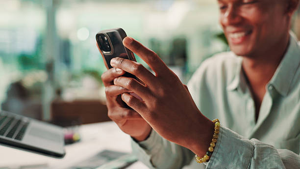 istock Hands, phone and man in office with contact, communication or social networking with chatting. Technology, connectivity and male journalist with internet search or texting on cellphone in workplace. 2225894989