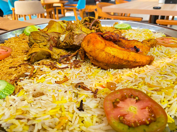 istock Biryani topped with roasted chicken, tender lamb, and garnished 2225902600