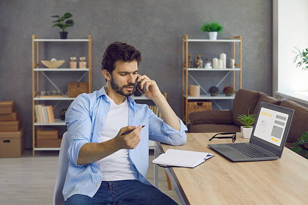 istock Serious young entrepreneur has a business conversation on the phone and takes notes. 2225905812