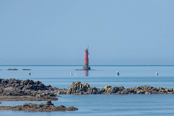 istock a red lighthouse on the sea. 2225906735