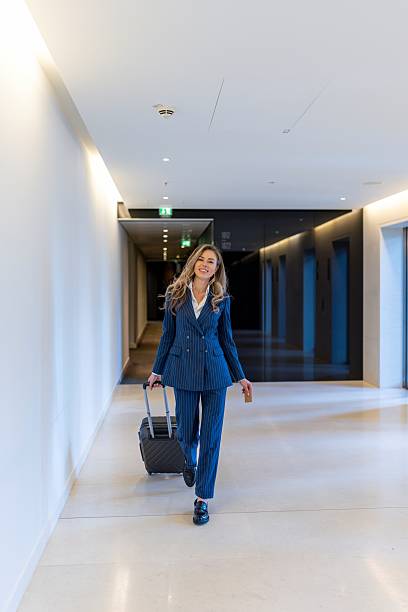 istock A Professional Woman Walking Through a Stylish, Modern Office Environment Exuding Elegance 2225907795