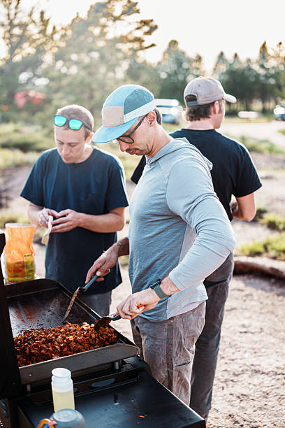 istock Men grilling at campsite 2225910433