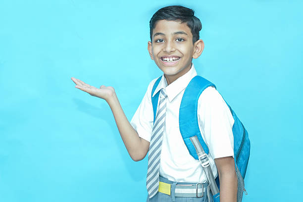 A close-up of a playful boy sticking out his tongue with a cheerful expression.