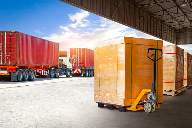 istock Bulk of Package Boxes Waiting to be Loaded into Containers Trucks. Distribution Warehouse, Shipping Cargo Container. Semi Trailer Trucks on The Parking Lot. Freight Truck Logistics Transportation. 2225910786