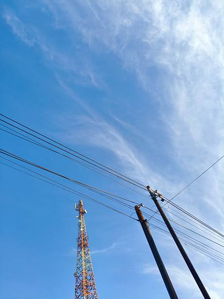 istock Cell Tower and telephone or internet Lines Against a Blue Sky 2225911291