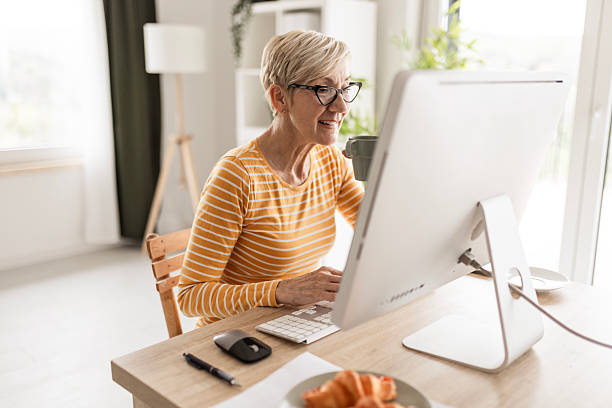 istock Cheerful Older Woman Using Laptop for Video Chat 2225922831